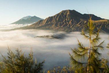Pinggan köyünden Bali 'deki Batur Yanardağı' nın gündoğumu manzarası. Güzel gün doğumu ve alçak bulutlar. Panoramik görünüm.