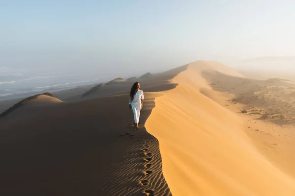 Frau Weißen Kleidern Spaziert Über Eine Riesige Sanddüne Der Nähe — Stockfoto