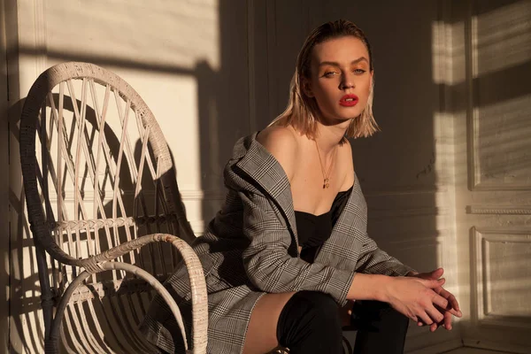 Trendy blonde woman sits in a Chair beautifully — Stock Photo, Image