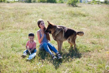 mom and son playing with dog sheepdog training