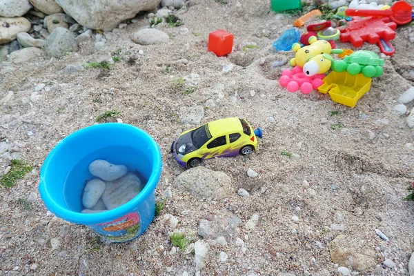 childrens toys scattered on the sandy beach 1