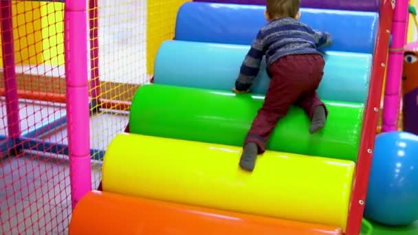 O menino brincando no playground com brinquedos — Vídeo de Stock