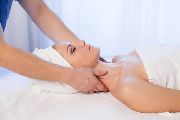 Woman doing massage of the face and neck treatments — Stock Photo, Image