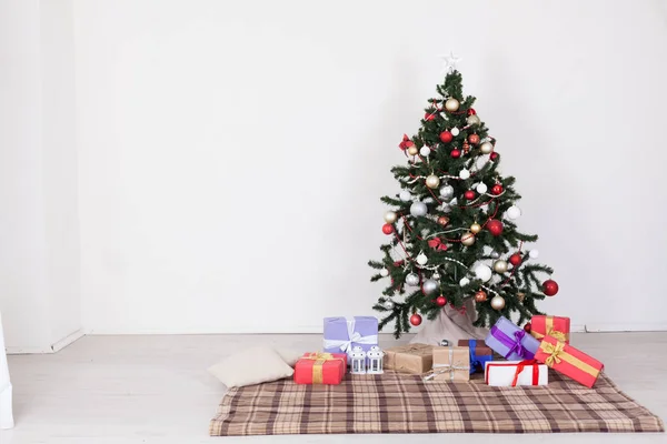 Рождественская елка с подарками из игрушек с гирляндой нового года — стоковое фото