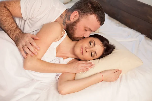 Husband and wife wake up in the morning in a bedroom love — Stock Photo, Image