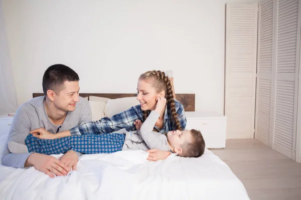 Mom dad and young son in the morning in bed after sleeping — Stock Photo, Image