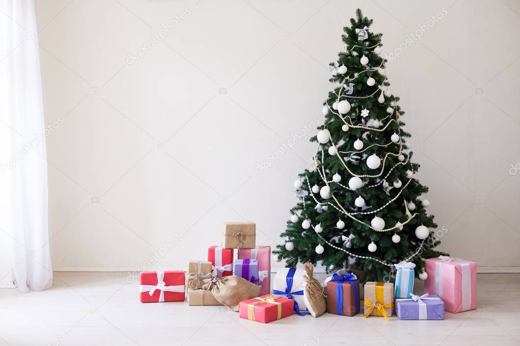 Green Christmas tree with gifts of toys for the new year holiday decor winter
