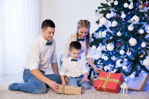 Man woman and young son sitting at the Christmas tree new year gifts holiday winter — Stock Photo, Image