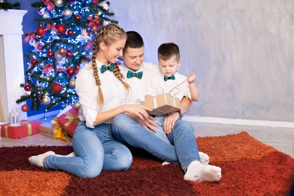 Man woman and young son sitting at the Christmas tree new year gifts holiday winter — Stock Photo, Image