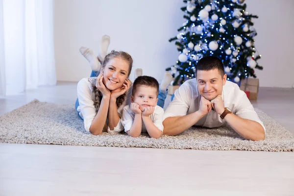 Mom dad and son decorate Christmas tree gifts new year tree winter holiday Garland — Stock Photo, Image