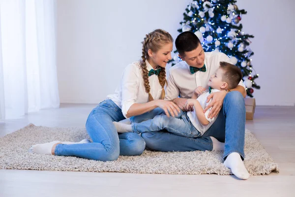 Mom dad and son decorate Christmas tree gifts new year tree winter holiday Garland — Stock Photo, Image