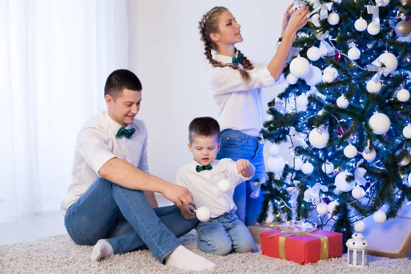 Mom dad and son decorate Christmas tree gifts new year tree winter holiday Garland — Stock Photo, Image