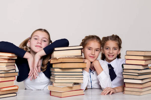 Drie meisjes in de klas studeren veel boeken — Stockfoto