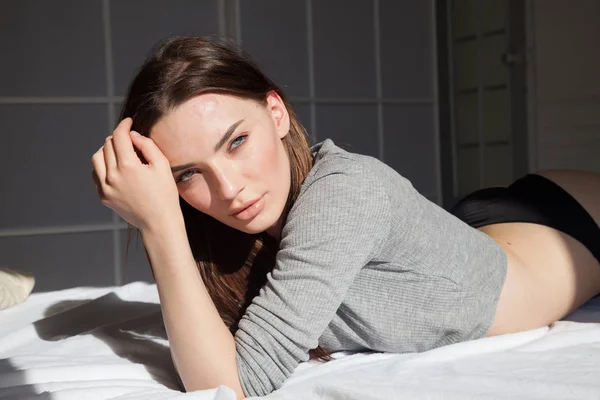 Bella donna in biancheria intima si trova sul letto in camera da letto — Foto Stock
