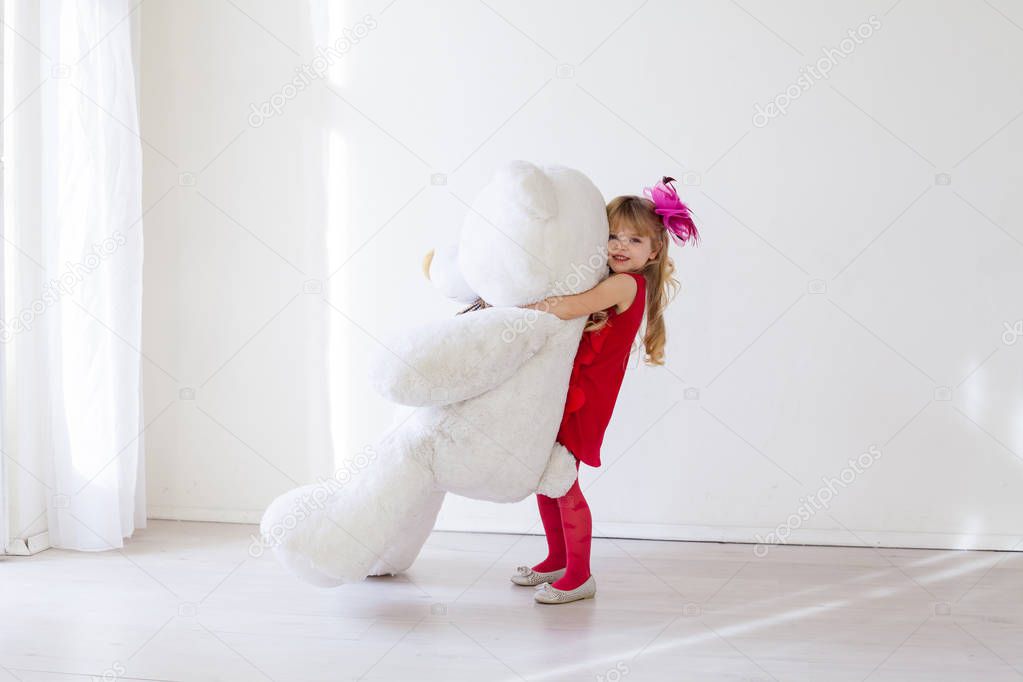 Beautiful girl with soft toy big bear