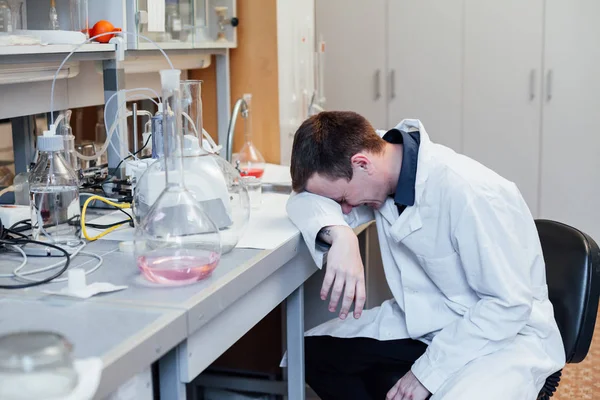 Scientist sleeps at work in the lab