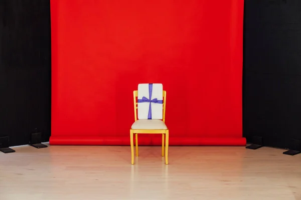 red black background room and golden chair with gift
