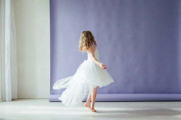 Hermosa chica rubia en vestido bailando sola en casa —  Fotos de Stock