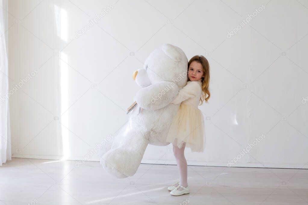 Little girl with big soft toy polar bear