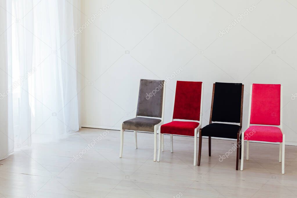 four chairs in the interior of an empty white room