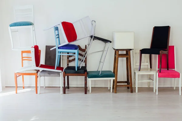 Veel veelkleurige stoelen in het interieur van de witte kamer — Stockfoto