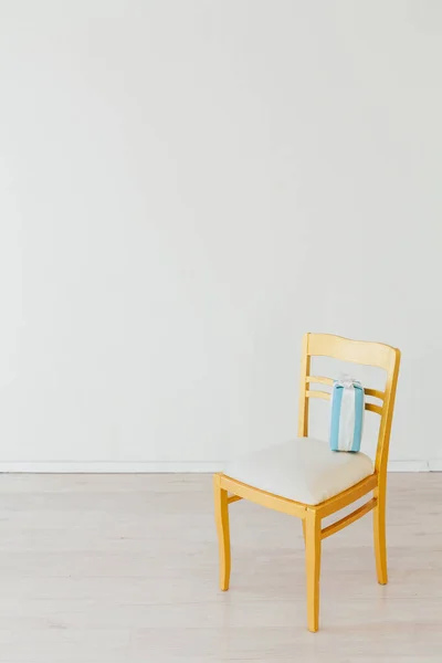 one chair with a gift in the interior of a white empty room