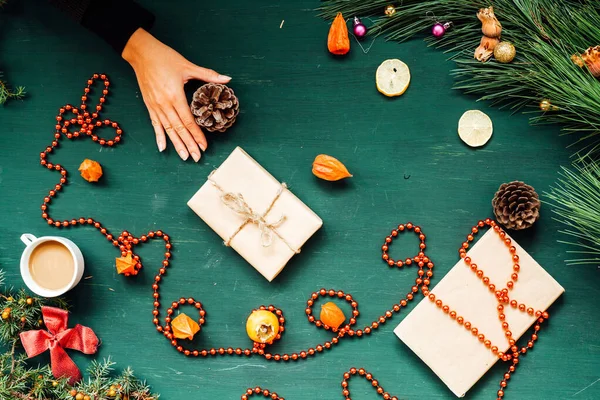 Christmas decorations hand amid Christmas trees and gifts