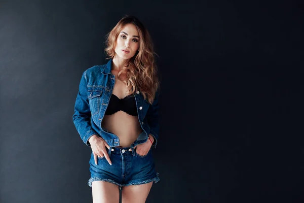 Portrait of a fashionable beautiful woman in denim shorts jacket and lingerie — Stock Photo, Image