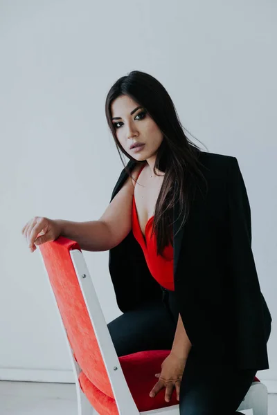 Bella donna bruna in abito da lavoro nero rosso in ufficio bianco — Foto Stock