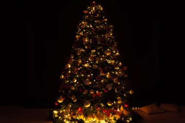 Noel ağacı çamı, gece odasının içinde yeni yıl için çiçek ışıklarının hediyeleriyle bir zemin olarak.