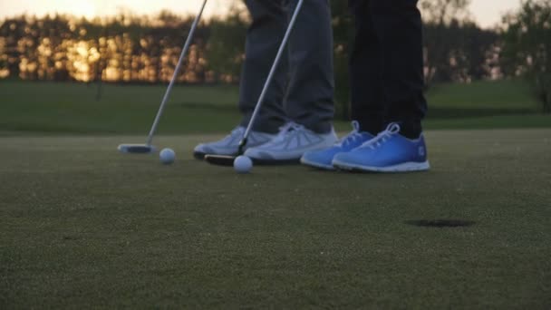 Gelukkig man met zijn zoon golfers wandelen op perfecte golfbaan op zomerdag — Stockvideo
