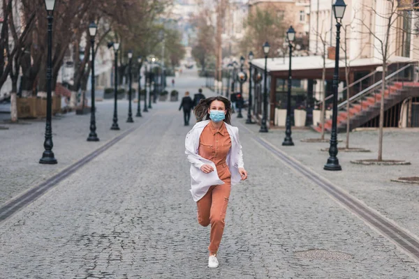 Brunette Woman Orange Clothes Wearing White Medical Coat Protective Mask Royalty Free Stock Images