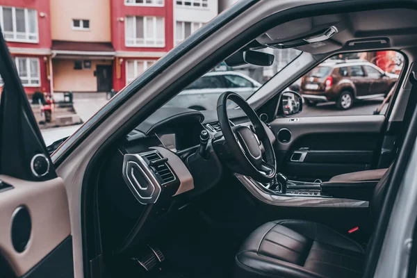 Dark luxury car Interior - steering wheel, shift lever and dashboard. Car interior luxury. steering wheel, speedometer, display, seats