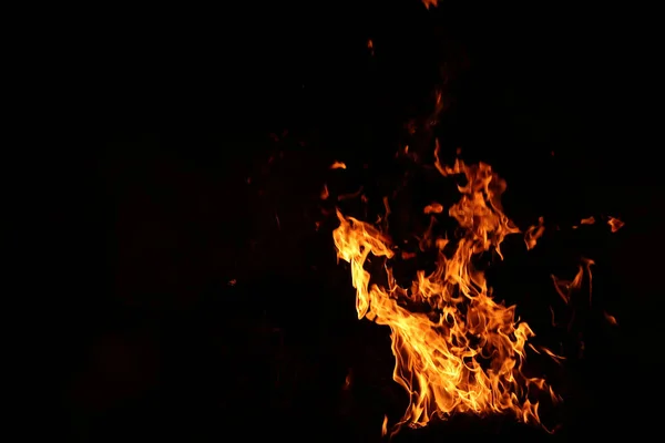 Fire, wood and straw. Fire cave. The elements of nature:  fire. Background with fire for phones and tablets. Fire on black background. Underground fire.