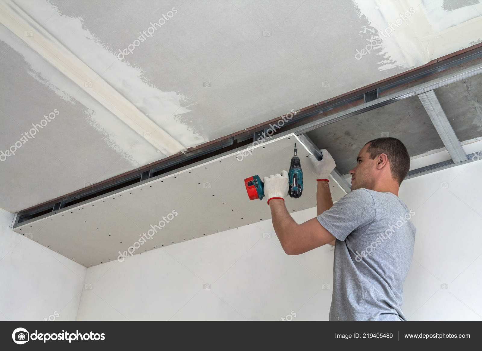 Young Man Usual Clothing Work Gloves Fixing Drywall