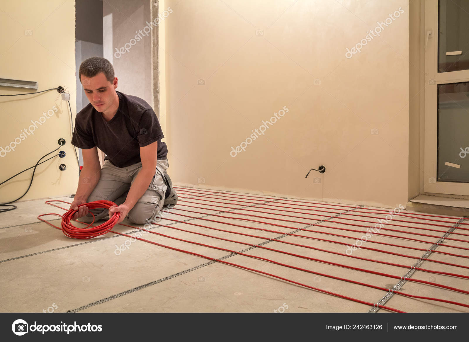 Electrician Installing Heating Red Electrical Cable Wire Cement