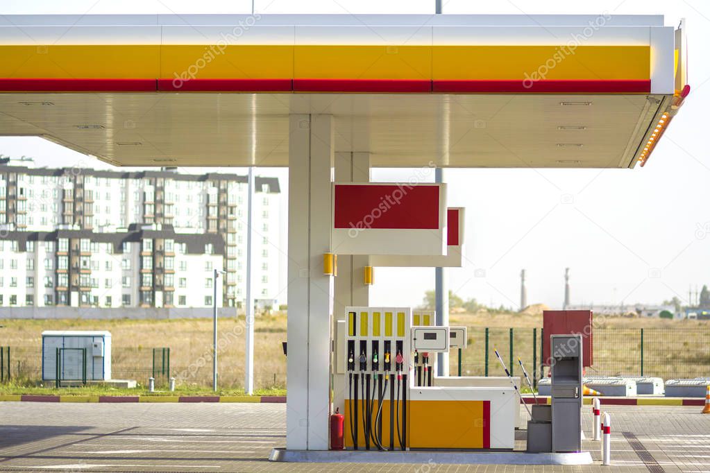 Clean empty auto gas station exterior on sunny day on rural landscape and bright sky copy space background.