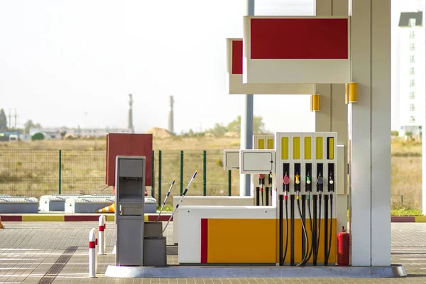 Clean empty auto gas station exterior on sunny day on rural landscape and bright sky copy space background.