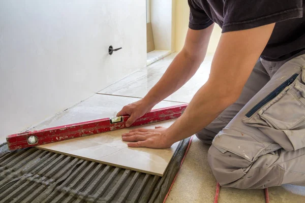 Young Worker Tiler Installing Ceramic, How To Install Ceramic Tile On Heated Floor