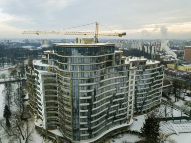 Daire veya işyeri bina yapım aşamasında, havadan görünümü. Kule vinç siluet mavi gökyüzü kopya alan arka plan üzerinde.