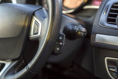 Lüks araba iç. Pano ve direksiyon siyah gri renkte. Ulaşım, tasarım, modern teknoloji kavramı.