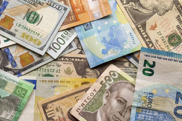 Colorful abstract background of different banknotes., Ukrainian national currency bills, American dollars and euro. Money and finances, succesful investment concept. — Stock Photo, Image