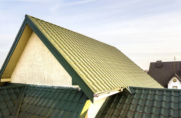 Green metal shingled house roof top.