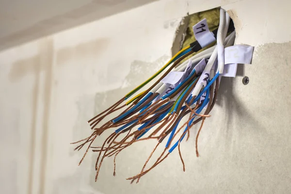 Electrical exposed connected wires protruding from socket on whi — Stock Photo, Image