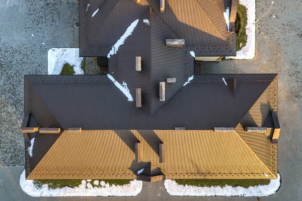 Top aerial view of building brown shingle tiled roof with comple