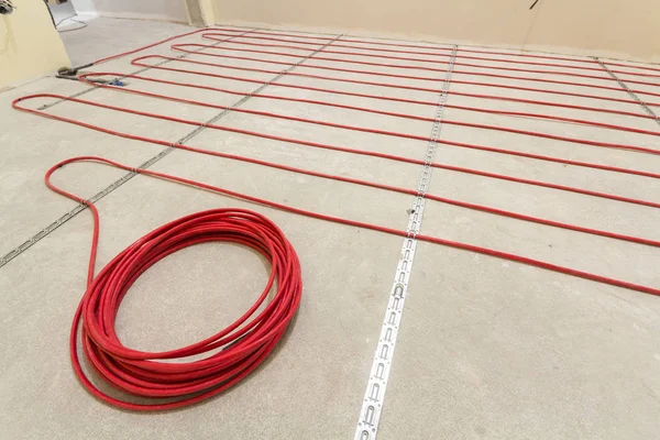 Heating red electrical cable wire roll on cement floor copy spac