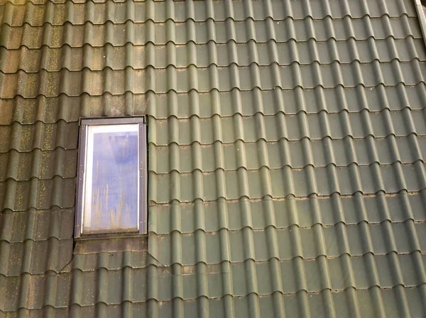 Close-up of new attic plastic window installed in shingled house — Stock Photo, Image