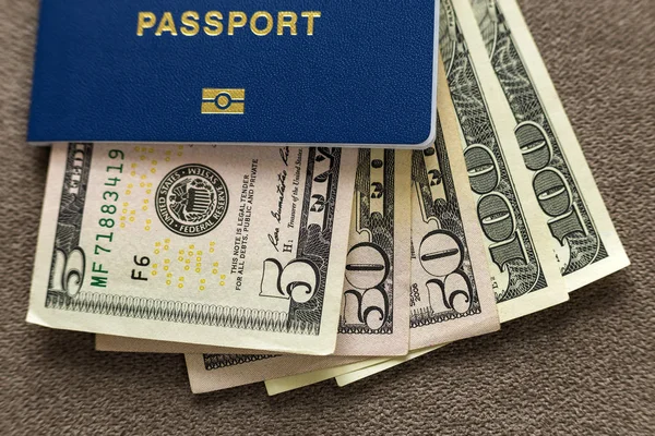 Travel passport and money, American dollars banknotes bills on c