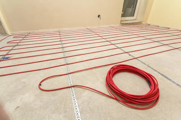 Heating red electrical cable wire roll on cement floor copy spac