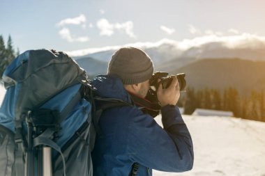 Sırt çantası ile sıcak giyim Hiker adam turist fotoğrafçı bir